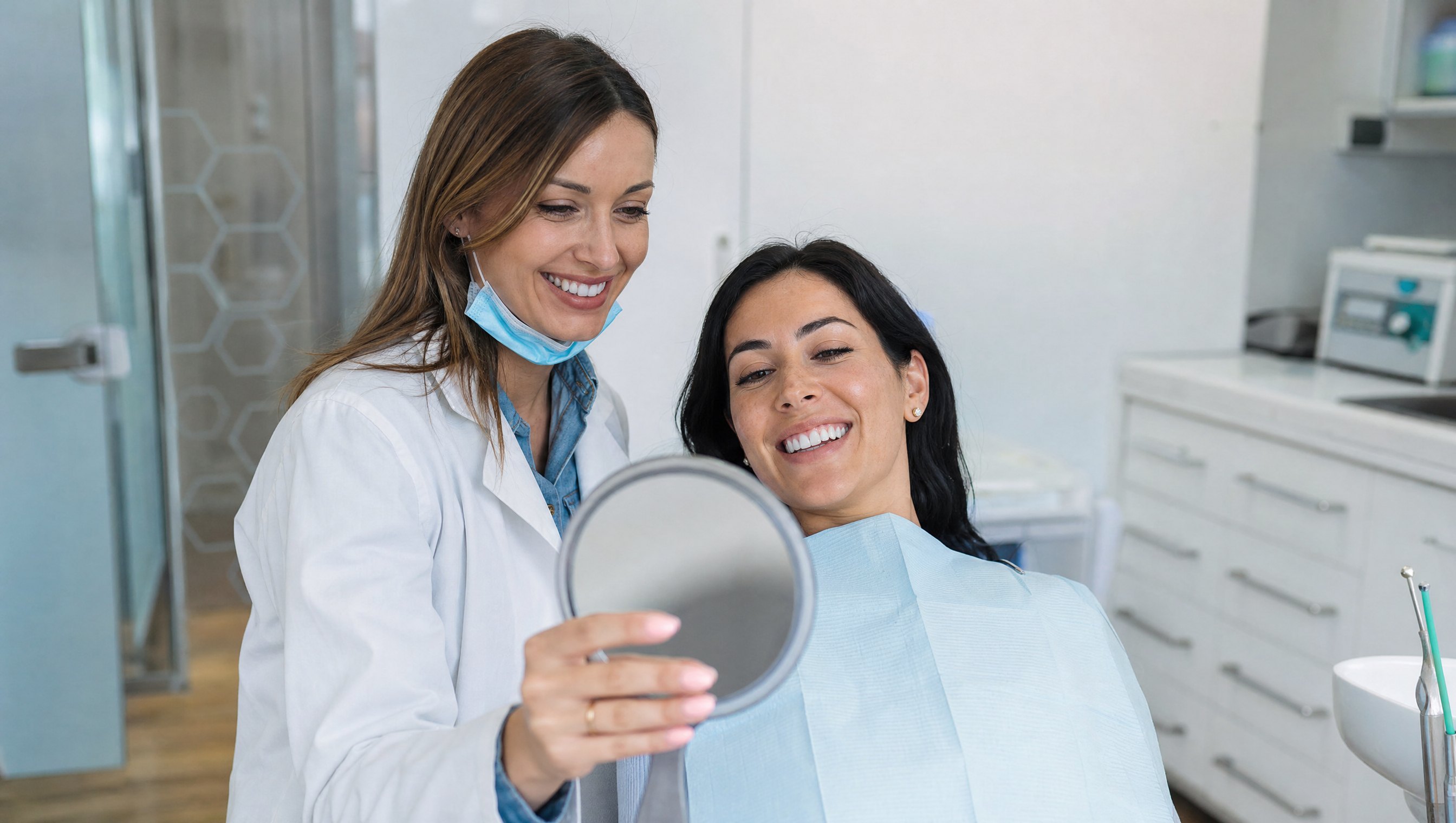 Dentist showing patient her new smile
